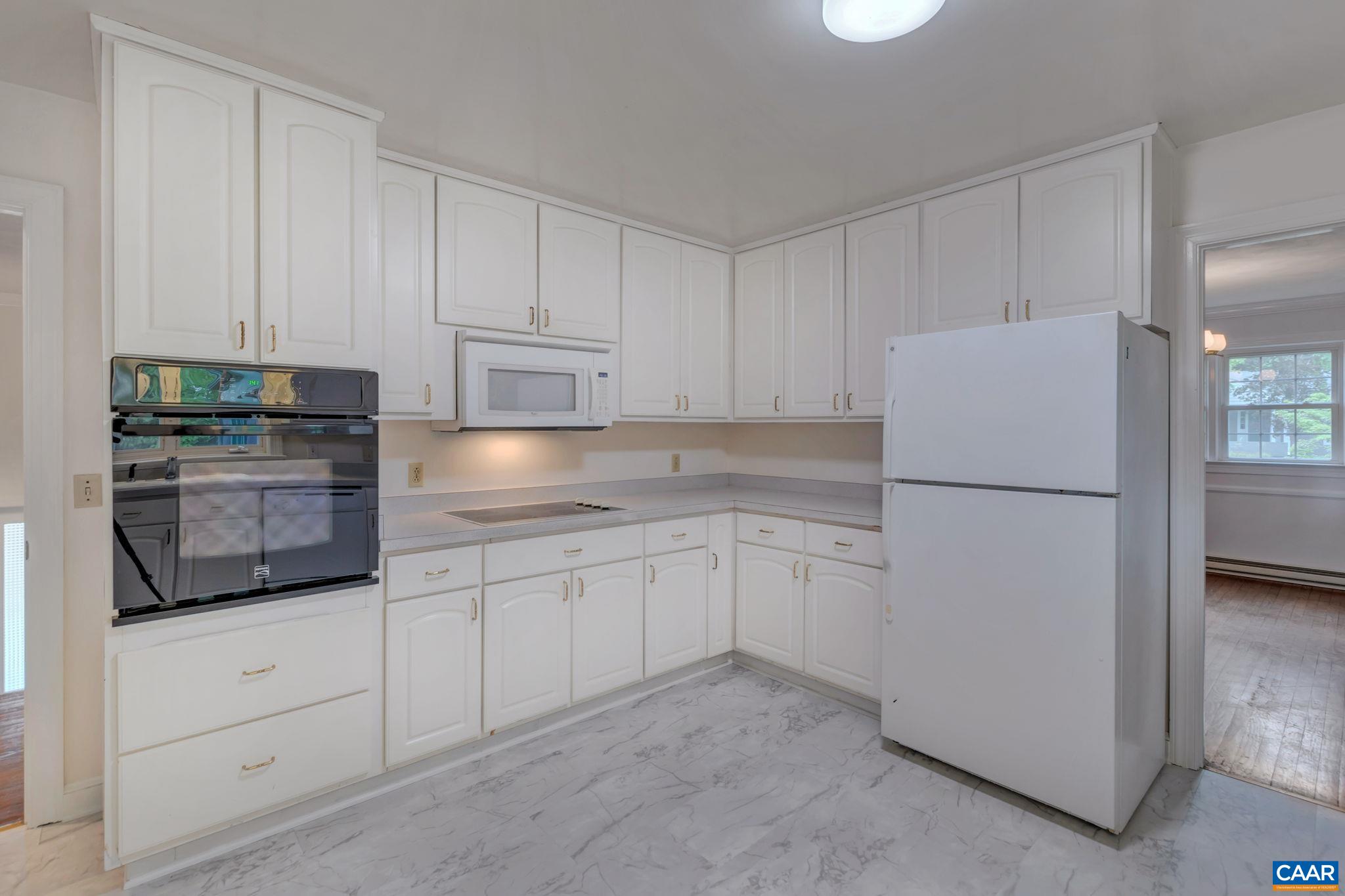 2602 Bennington Road Charlottesville, VA 22901 - Photo 13 of 50 a kitchen with granite countertop white cabinets and refrigerator