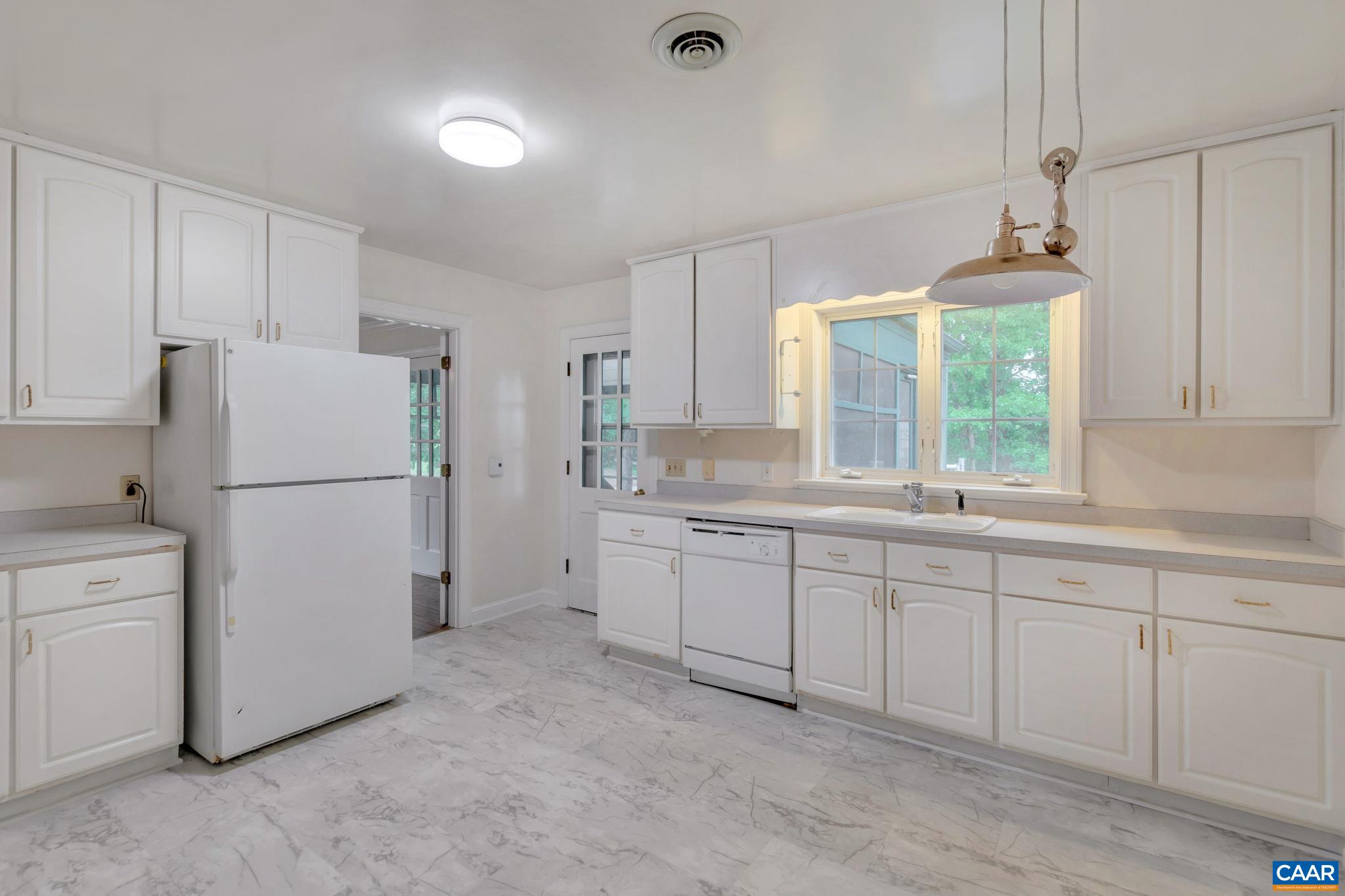 2602 Bennington Road Charlottesville, VA 22901 - Photo 14 of 50 a kitchen with white cabinets and white appliances