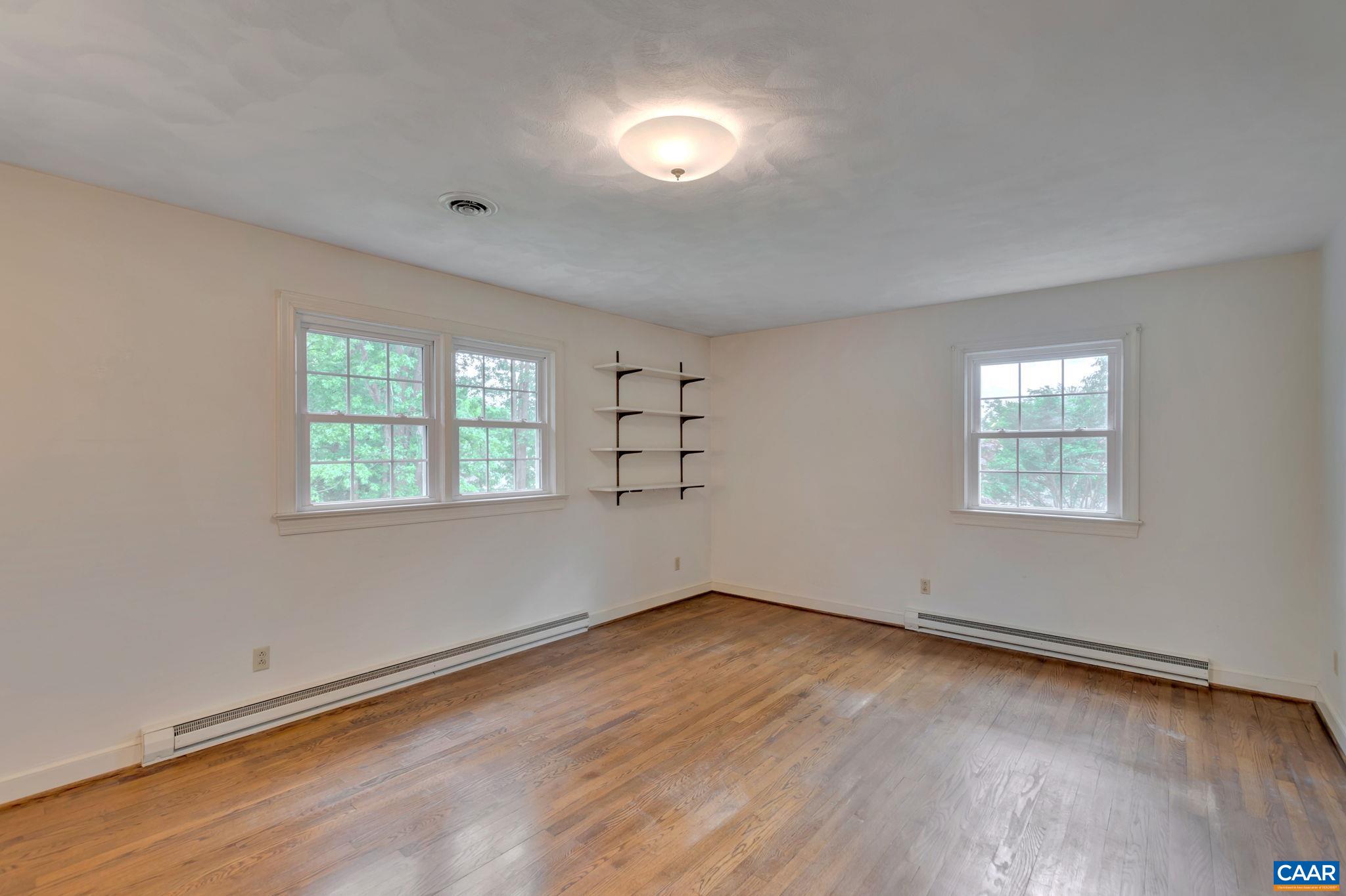 2602 Bennington Road Charlottesville, VA 22901 - Photo 17 of 50 an empty room with wooden floor and windows