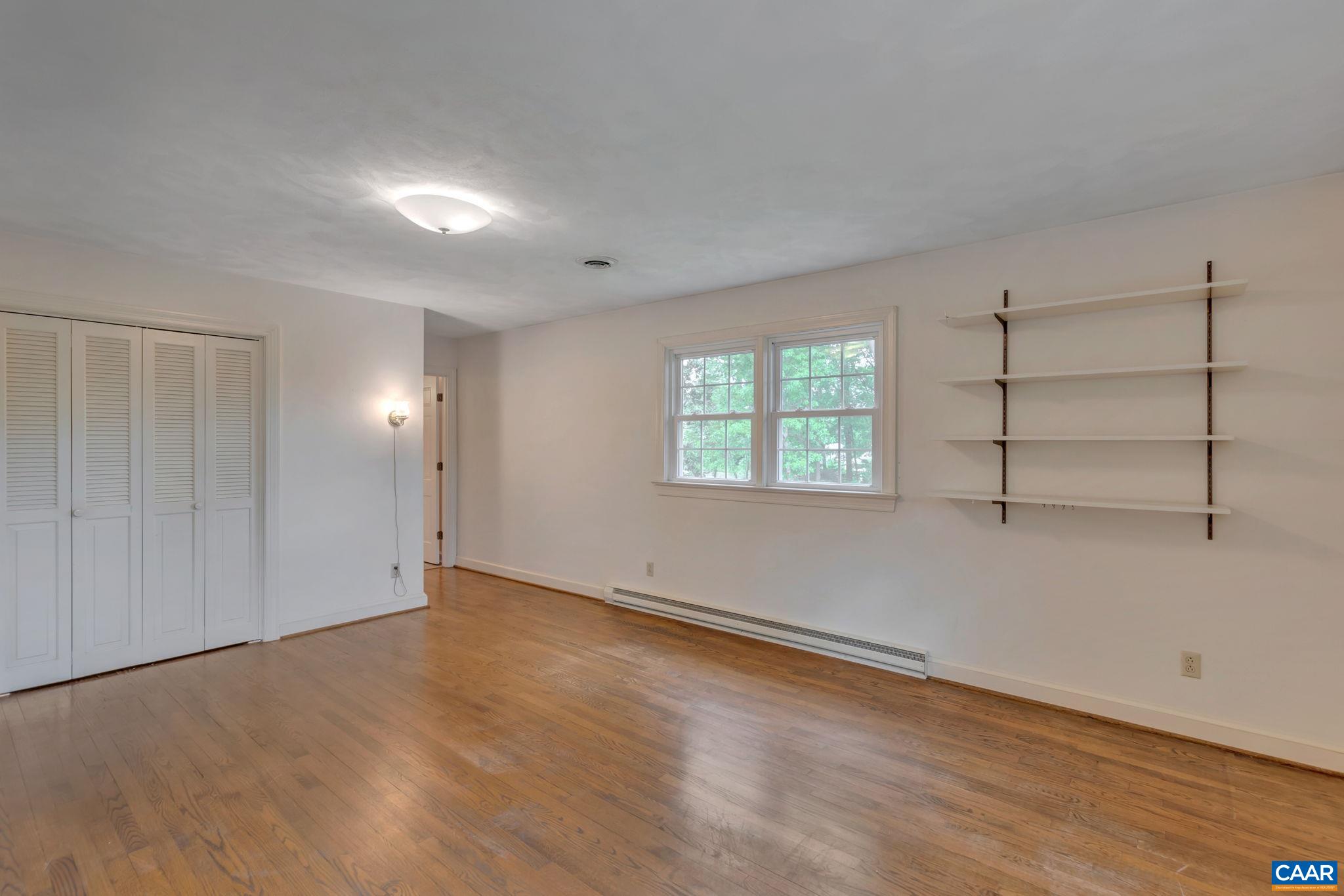 2602 Bennington Road Charlottesville, VA 22901 - Photo 18 of 50 an empty room with wooden floor and windows