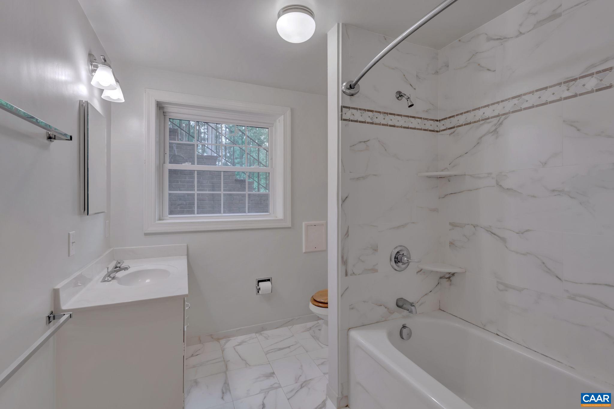 2602 Bennington Road Charlottesville, VA 22901 - Photo 30 of 50 a bathroom with a tub sink vanity and mirror