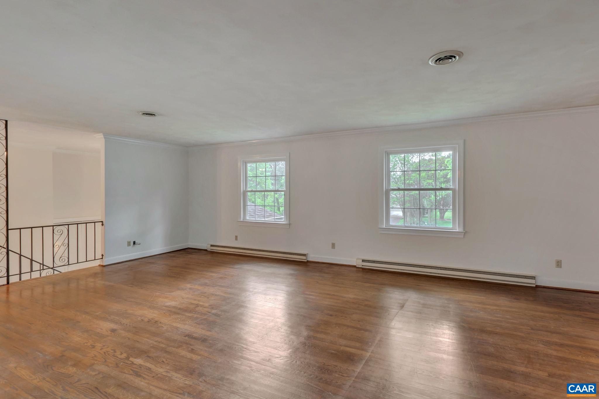 2602 Bennington Road Charlottesville, VA 22901 - Photo 9 of 50 an empty room with wooden floor and windows