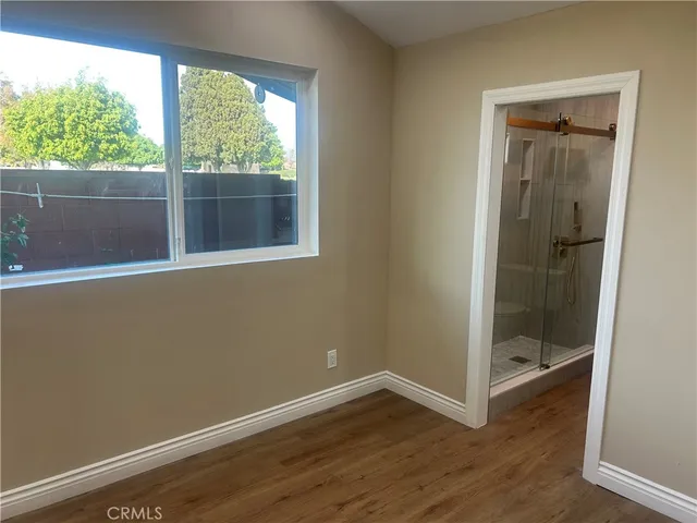 an entryway with wooden floor and staircase