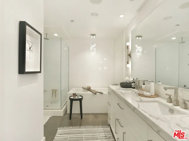a bathroom with a granite countertop sink a toilet and shower