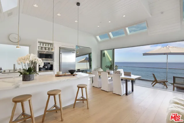 a large kitchen with a table and chairs
