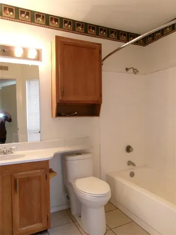 a bathroom with a sink a toilet and bathtub