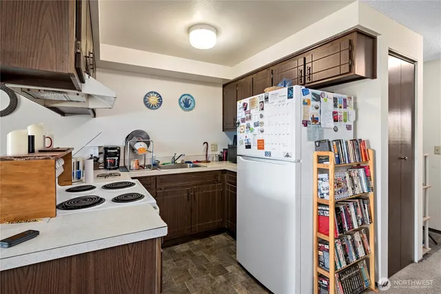 a kitchen with stainless steel appliances a refrigerator and a stove