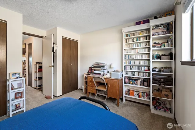 a bedroom with a bed and window