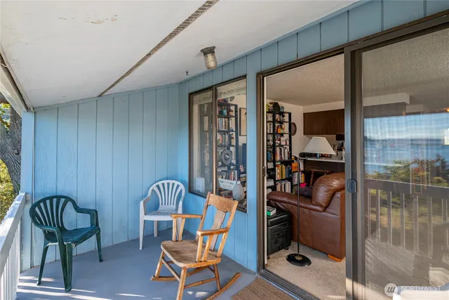a view of an chairs and table in the balcony
