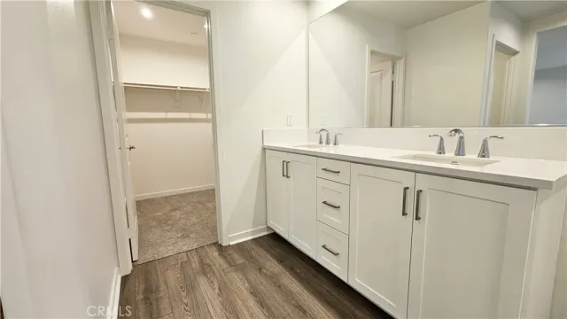 a bathroom with a double vanity sink and mirror