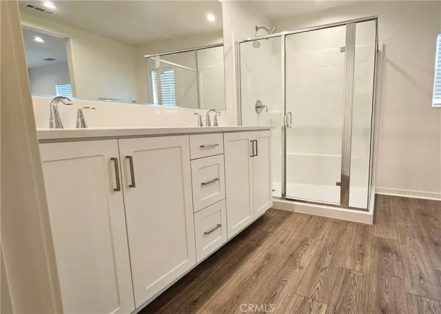 a bathroom with a sink a mirror and a shower