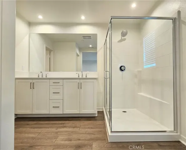 a bathroom with a glass shower door and a shower