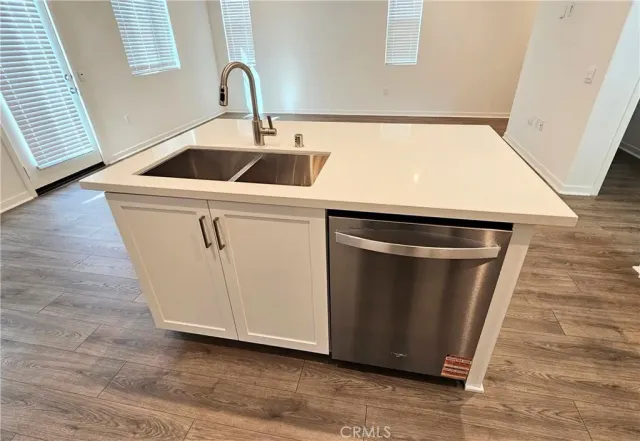 a close view of a sink and a microwave in a kitchen