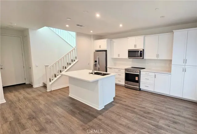 a view of kitchen with microwave oven and cabinets