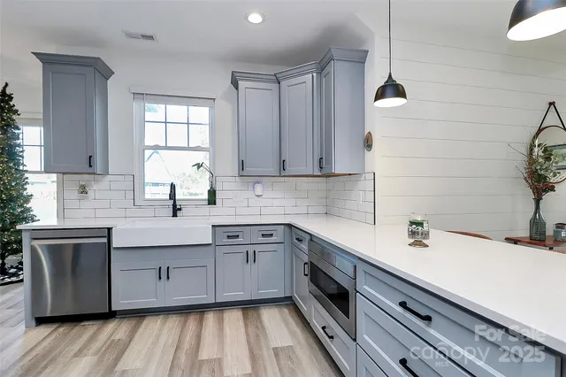 a kitchen with a sink cabinets and window