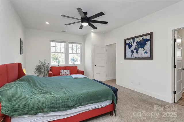 a bedroom with a large bed and a window