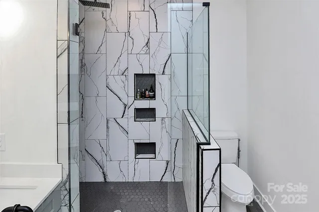 a white toilet sitting next to a bathroom sink