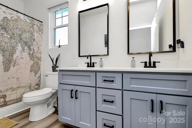 a bathroom with a sink toilet and mirror