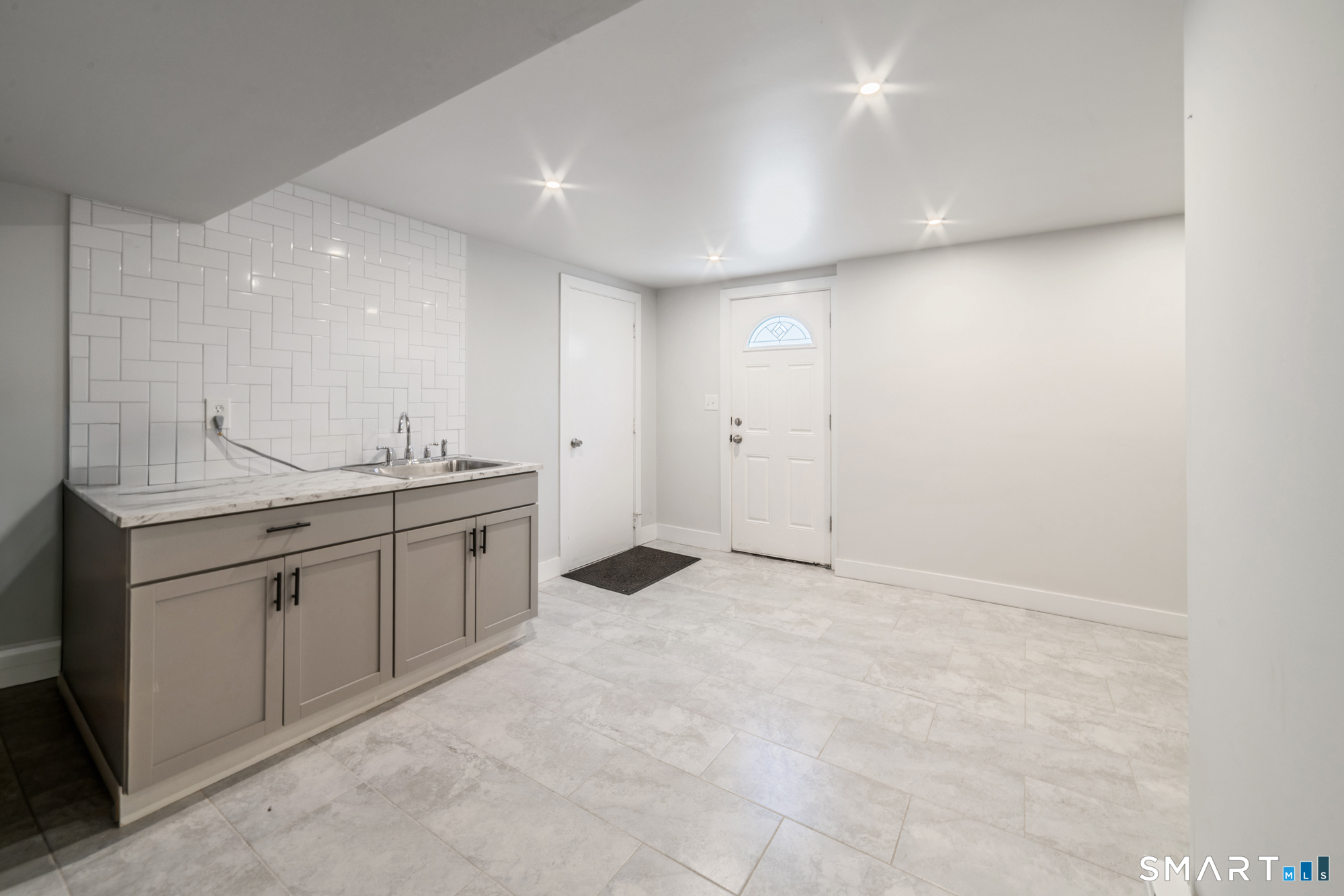 327 Lakeside Boulevard West Waterbury, CT 06708 - Photo 22 of 29 a spacious bathroom with a granite countertop sink and a mirror