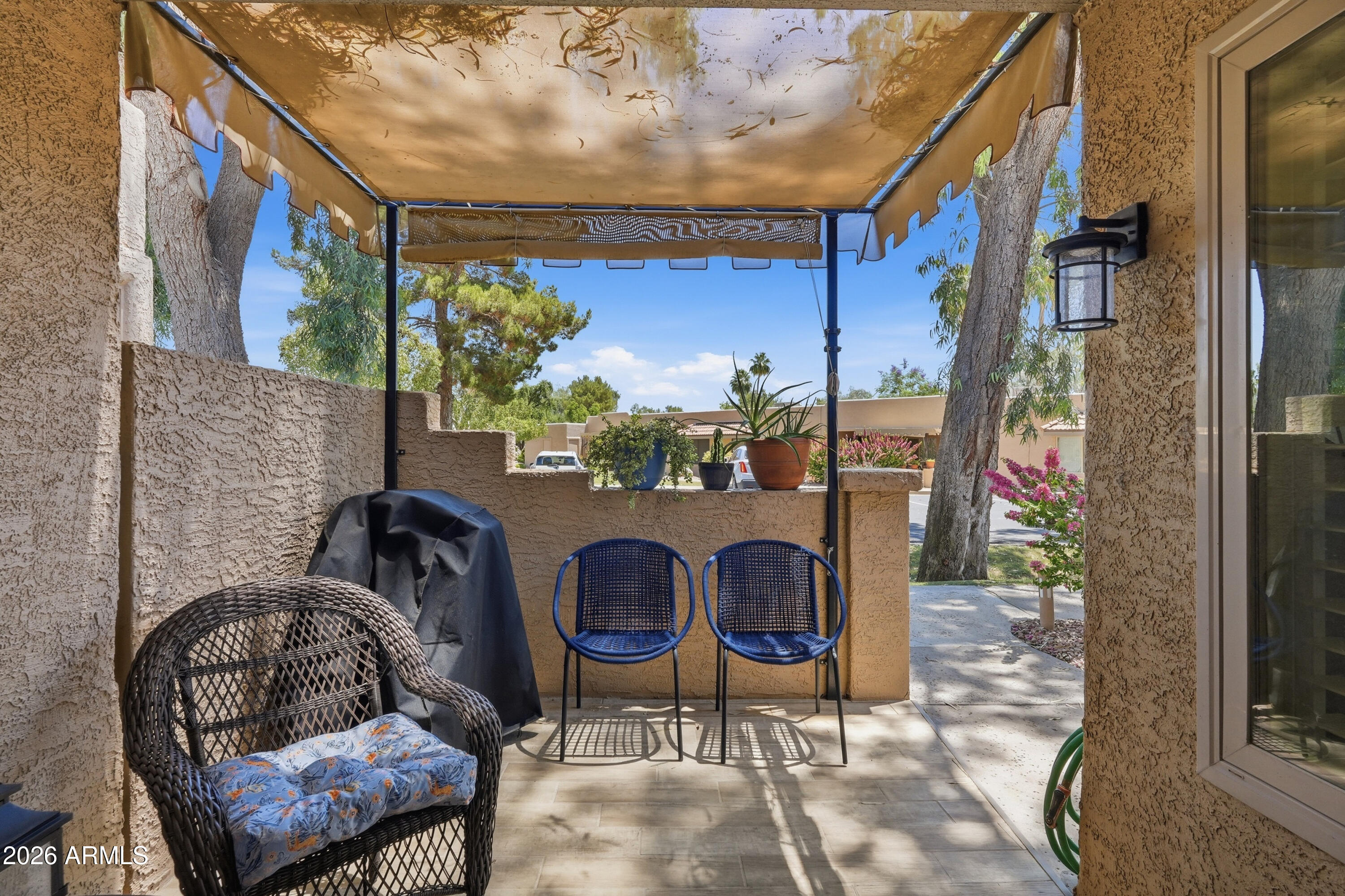 14300 West Bell Road, Unit 49 Surprise, AZ 85374 - Photo 2 of 19 a outdoor living room with furniture and a potted plant