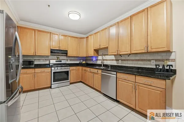 a kitchen with a stove a sink and a microwave