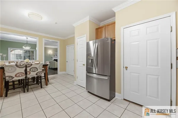 a kitchen with stainless steel appliances a refrigerator and a cabinets