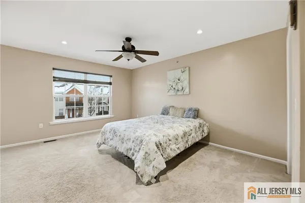 a bedroom with a large bed and a window