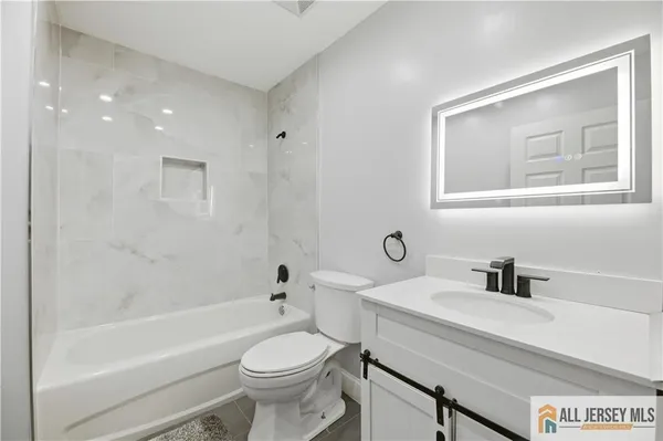 a bathroom with a sink a toilet and a bathtub