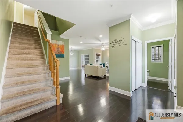 a view of entryway and hall with wooden floor
