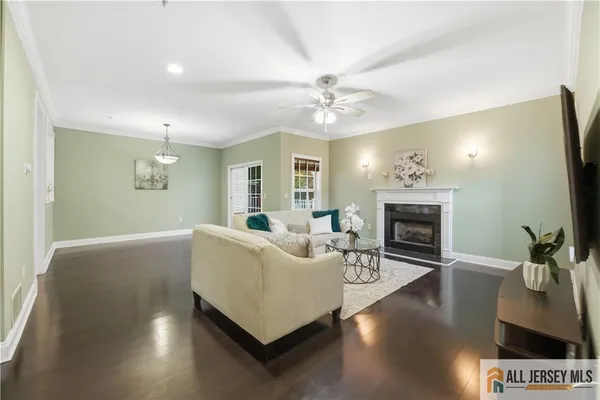 a living room with furniture a fireplace and a flat screen tv