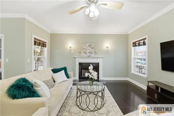a living room with furniture a fireplace and a flat screen tv