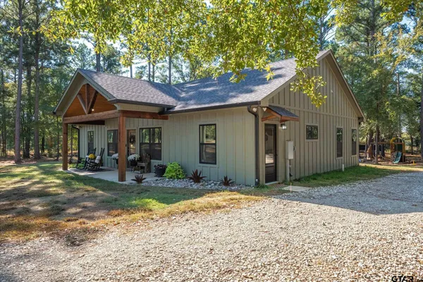 a view of a house with backyard porch and sitting area