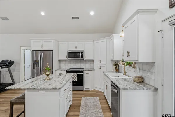 a kitchen with a sink stove and refrigerator