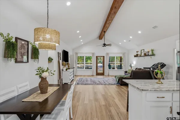 a living room with kitchen island furniture and a chandelier