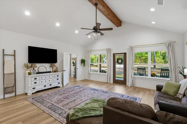 a living room with furniture and a flat screen tv
