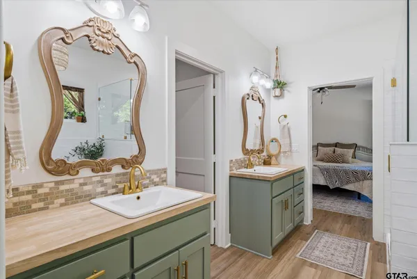 a bathroom with a sink double vanity and mirror