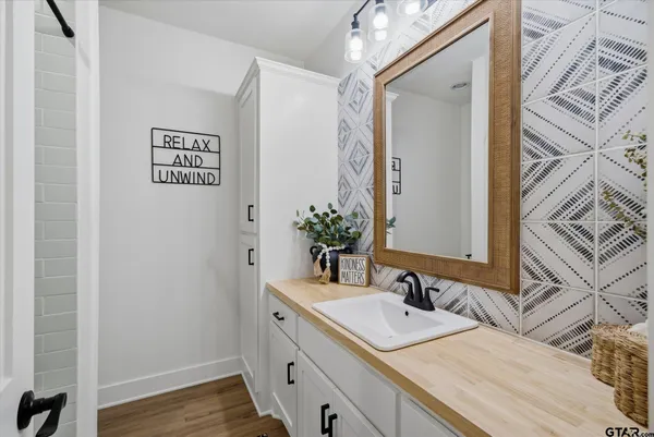 a bathroom with a sink and a mirror