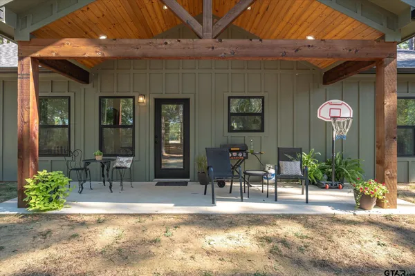 a view of a porch with dining table and chairs