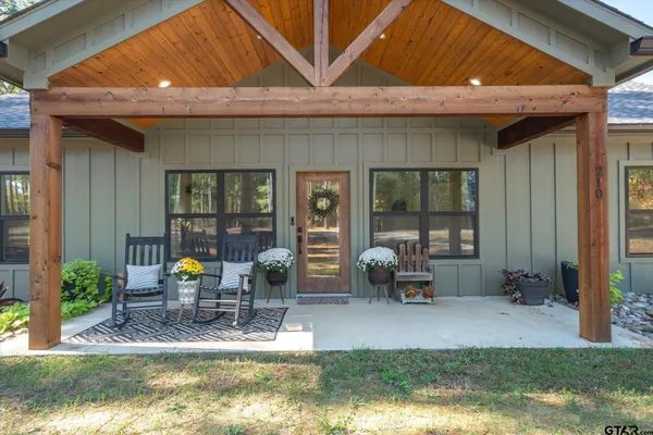 a view of a house with backyard porch and sitting area