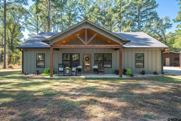 a view of a house with backyard porch and sitting area