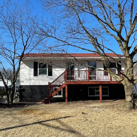 a view of a house with large trees