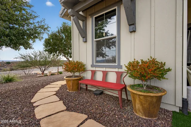 a living room with furniture a flat screen tv and kitchen view