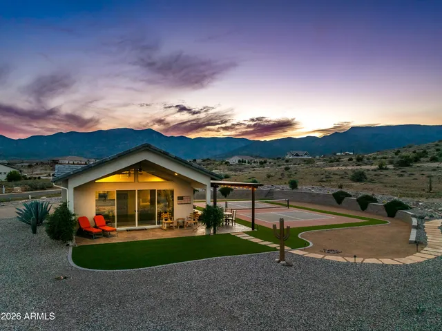 a kitchen with granite countertop a sink stove refrigerator and cabinets