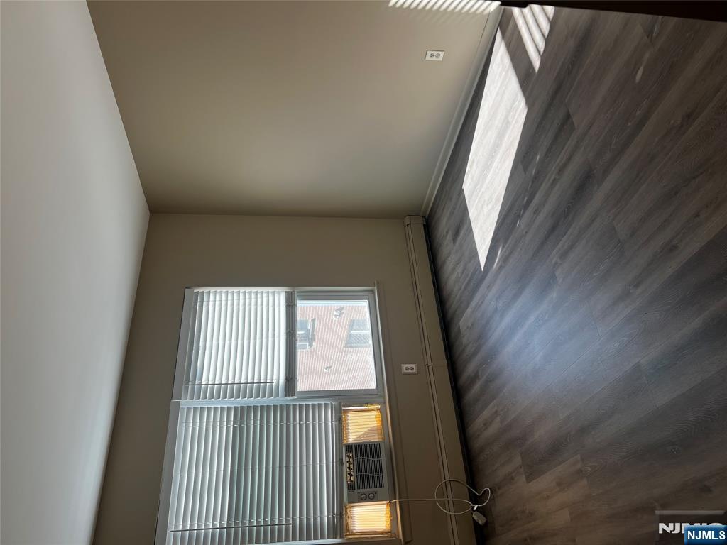 34 Riverview Court, Unit 34 Secaucus, NJ 07094 - Photo 12 of 16 an empty room with wooden floor and windows