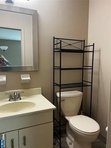 a bathroom with a sink vanity and toilet