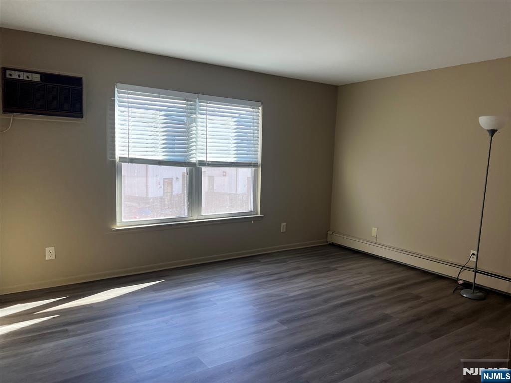 34 Riverview Court, Unit 34 Secaucus, NJ 07094 - Photo 16 of 16 an empty room with wooden floor and windows