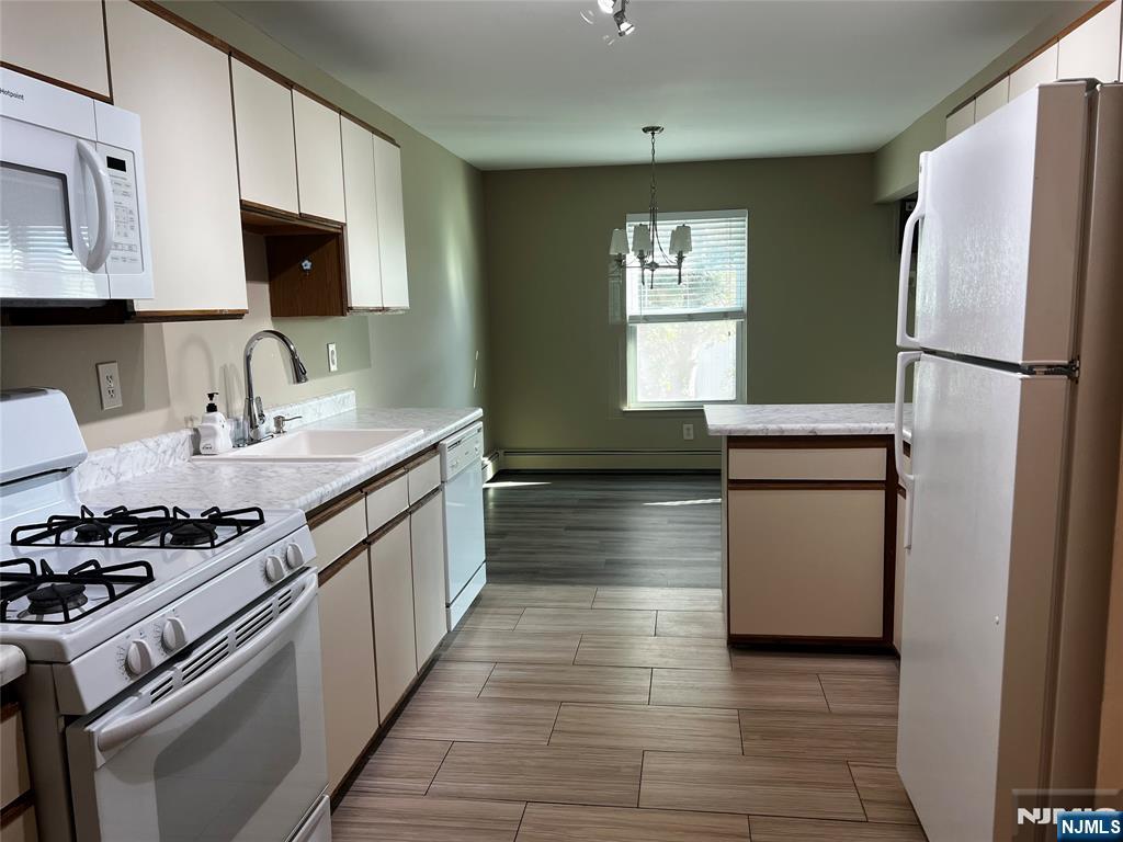 34 Riverview Court, Unit 34 Secaucus, NJ 07094 - Photo 3 of 16 a kitchen with stainless steel appliances a refrigerator stove and sink