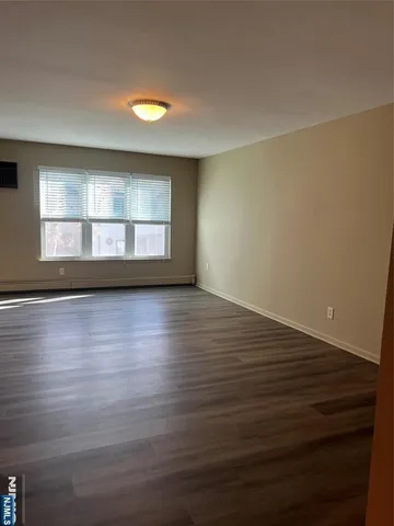 a view of an empty room and wooden floor