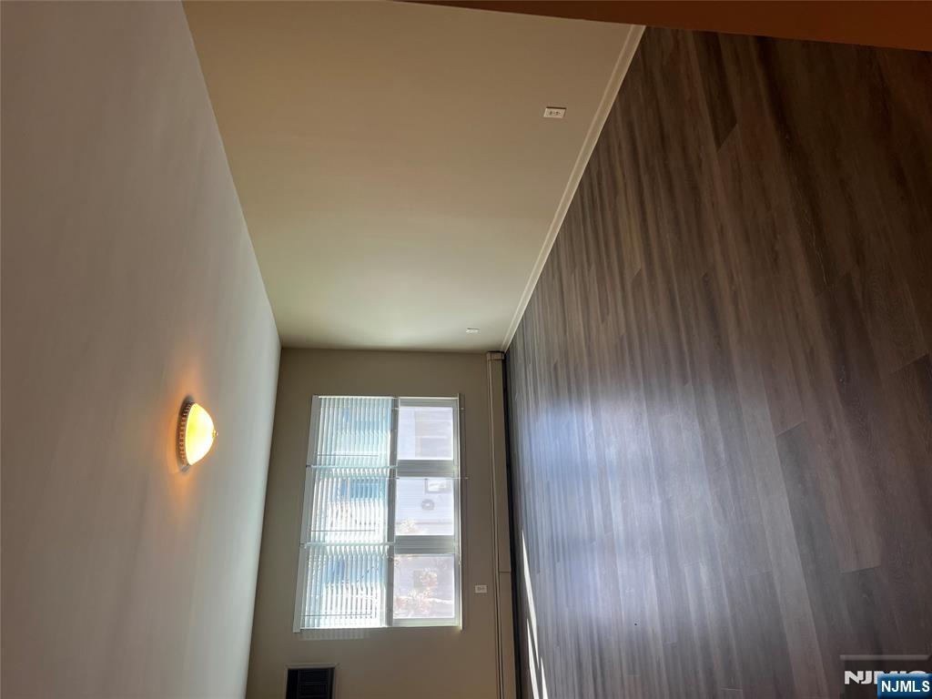 34 Riverview Court, Unit 34 Secaucus, NJ 07094 - Photo 6 of 16 wooden floor in an empty room with a window