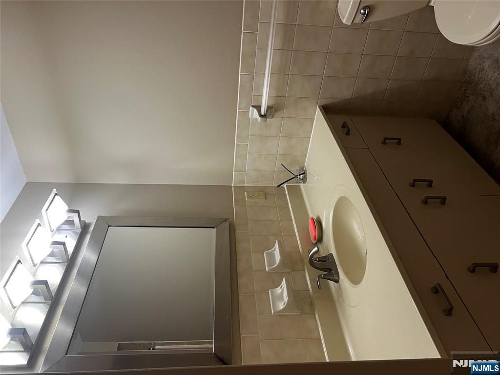 34 Riverview Court, Unit 34 Secaucus, NJ 07094 - Photo 10 of 16 a bathroom with a sink a toilet and mirror